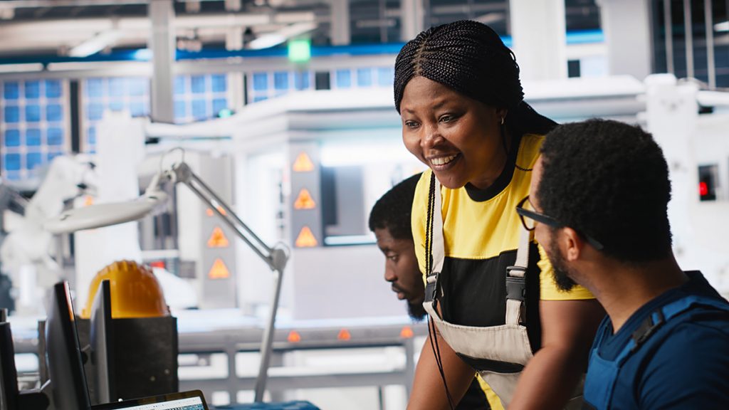 African american colleagues analyze power data from solar production line